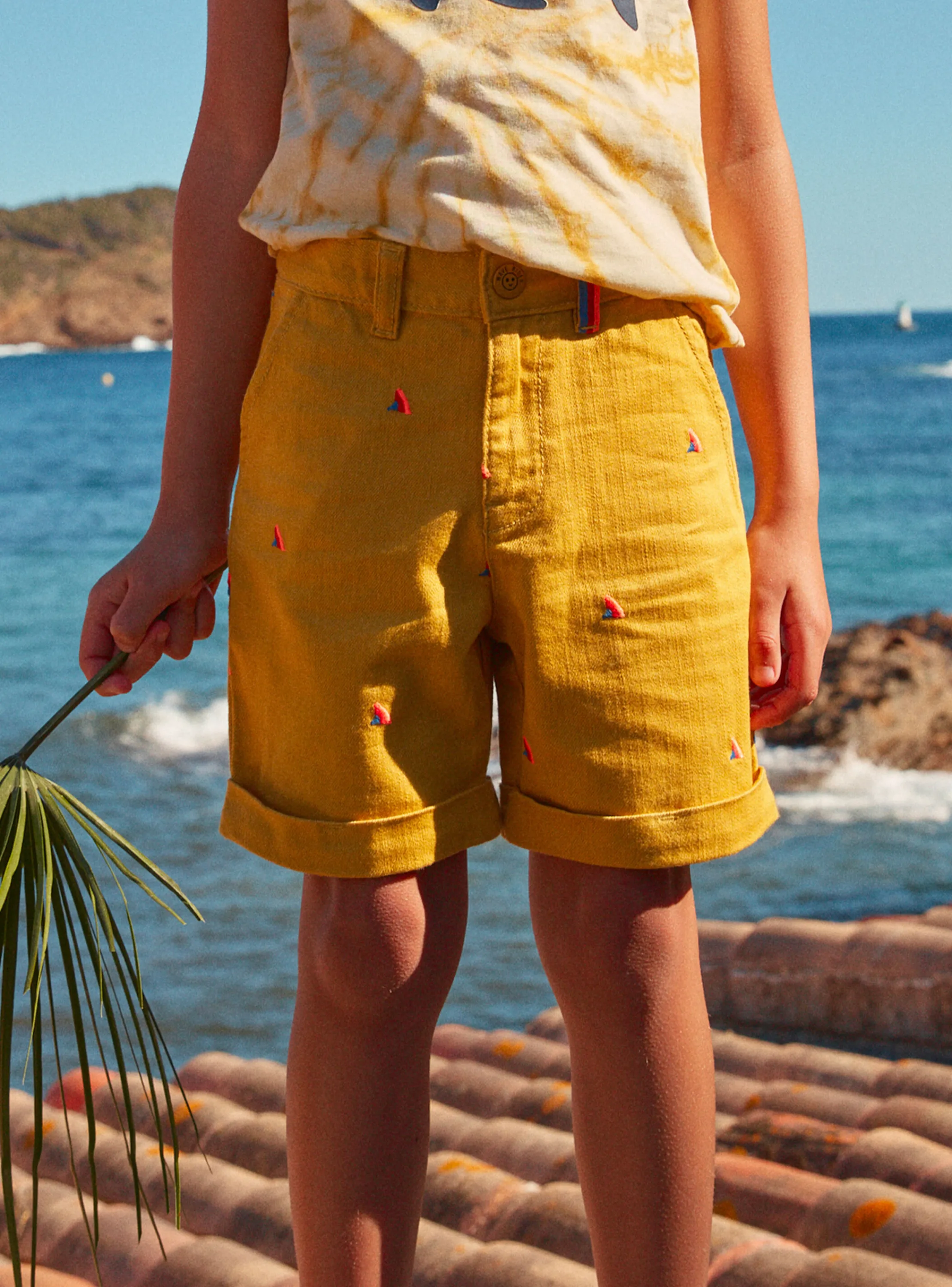 New Sergent Major Mustard shorts with multicoloured shark fin embroideries